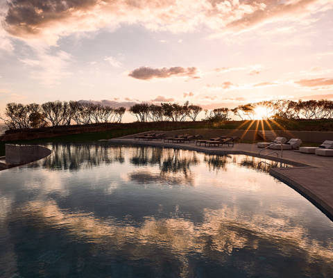 Zelia Resort Halkidiki Swimming Pool and sunbeds at sunset
