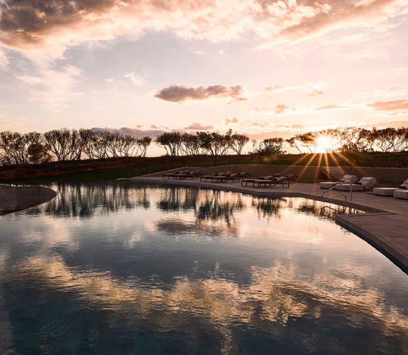 Zelia Resort Halkidiki Swimming Pool and sunbeds at sunset

