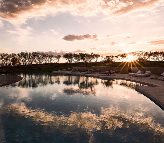 Zelia Resort Halkidiki Swimming Pool and sunbeds at sunset

