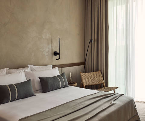 Zelia Resort Halkidiki Deluxe Double double bed and a chair
