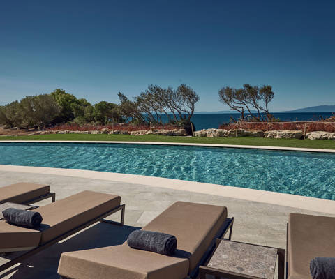 Zelia Resort Halkidiki Swimming Pool sunbeds and garden view
